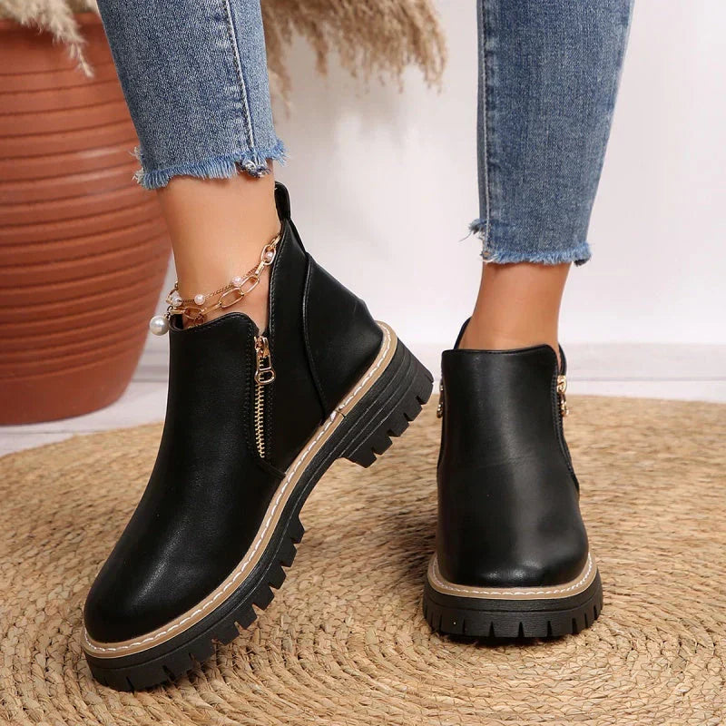 Robyn Comfort Ankle Boots in black leather with side zipper, worn on both feet - The Gold Coast Family
