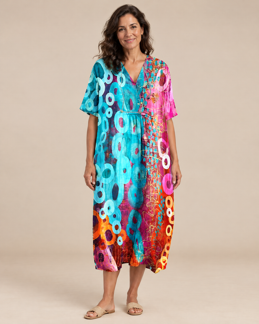 Addilyn vibrant tie dye summer dress, mature model in light beige studio