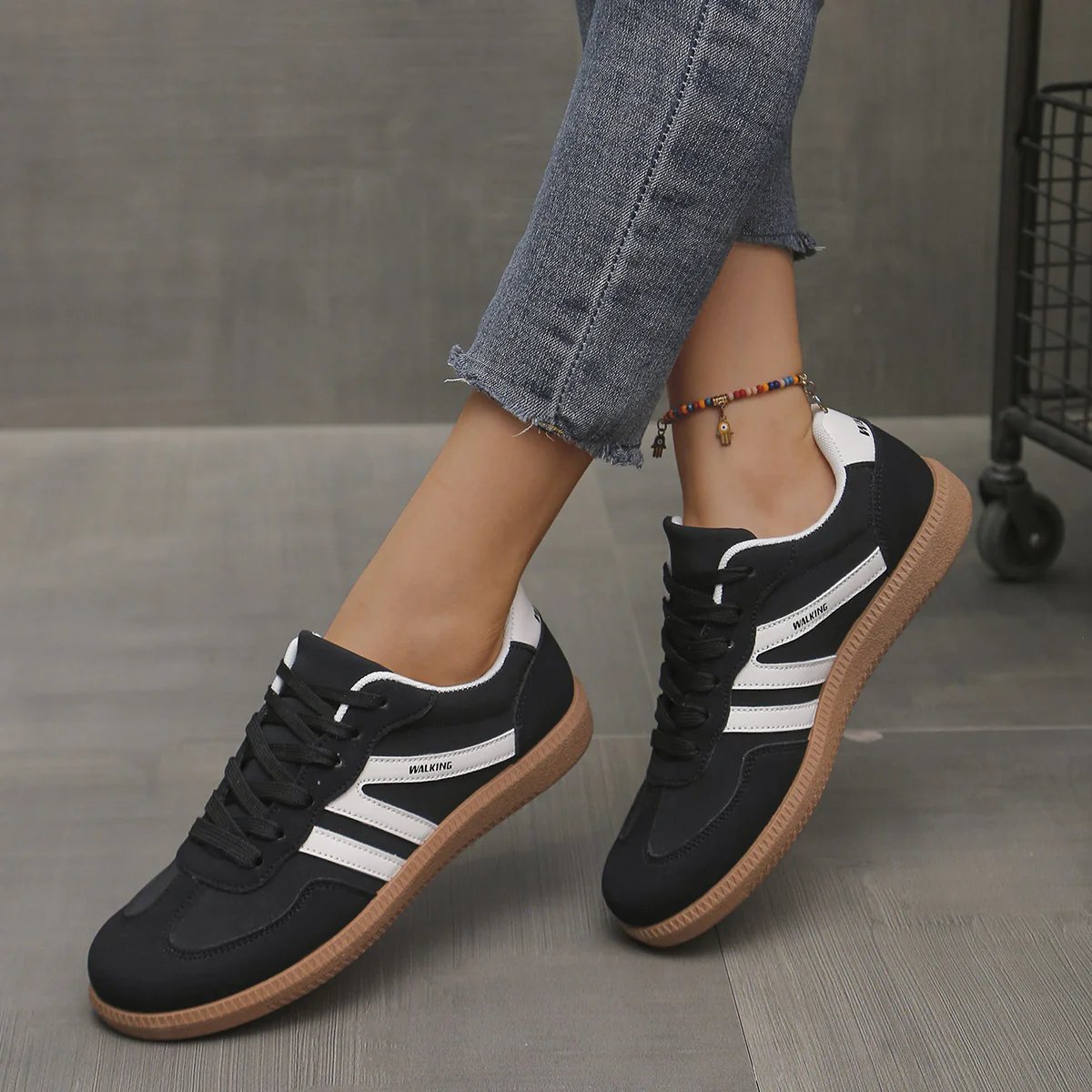 Briony Orthopaedic Cushioned Trainers in black with white stripe, worn on foot - The Gold Coast Family