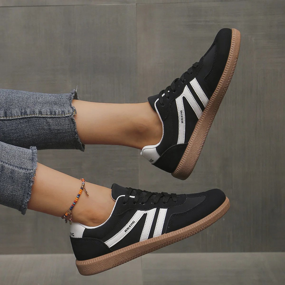 Briony Orthopaedic Cushioned Trainers in black with white stripe accents, worn on foot - The Gold Coast Family