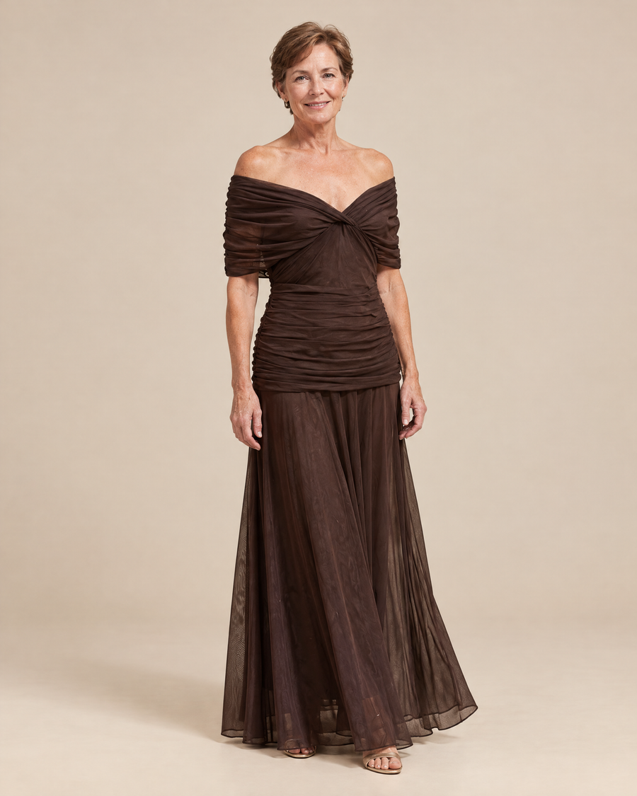 elegant brown occasion dress in a light beige studio