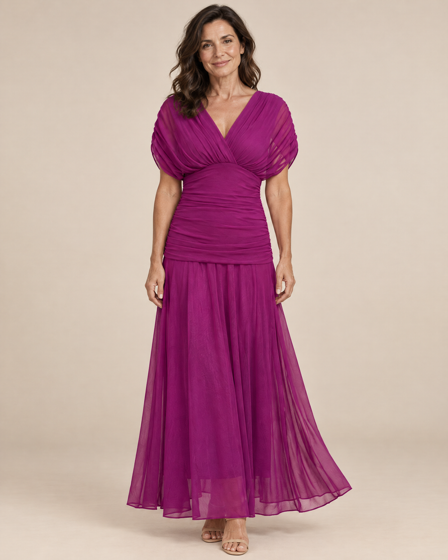 elegant fuchsia occasion dress in a light beige studio