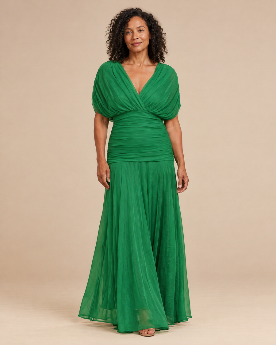 elegant kelly green occasion dress in a light beige studio